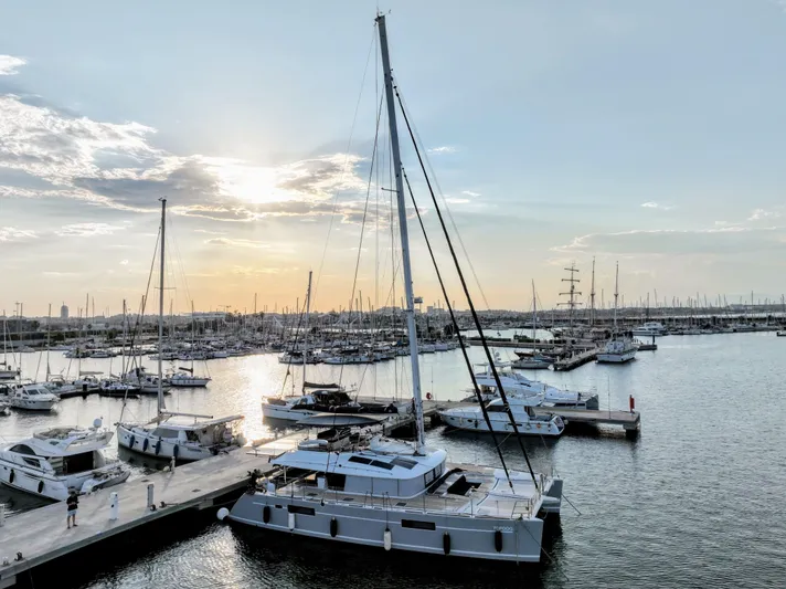 Topdog Yacht Photos Pics Lagoon 560 S2 catamaran docked at marina during sunset, 2018 model.