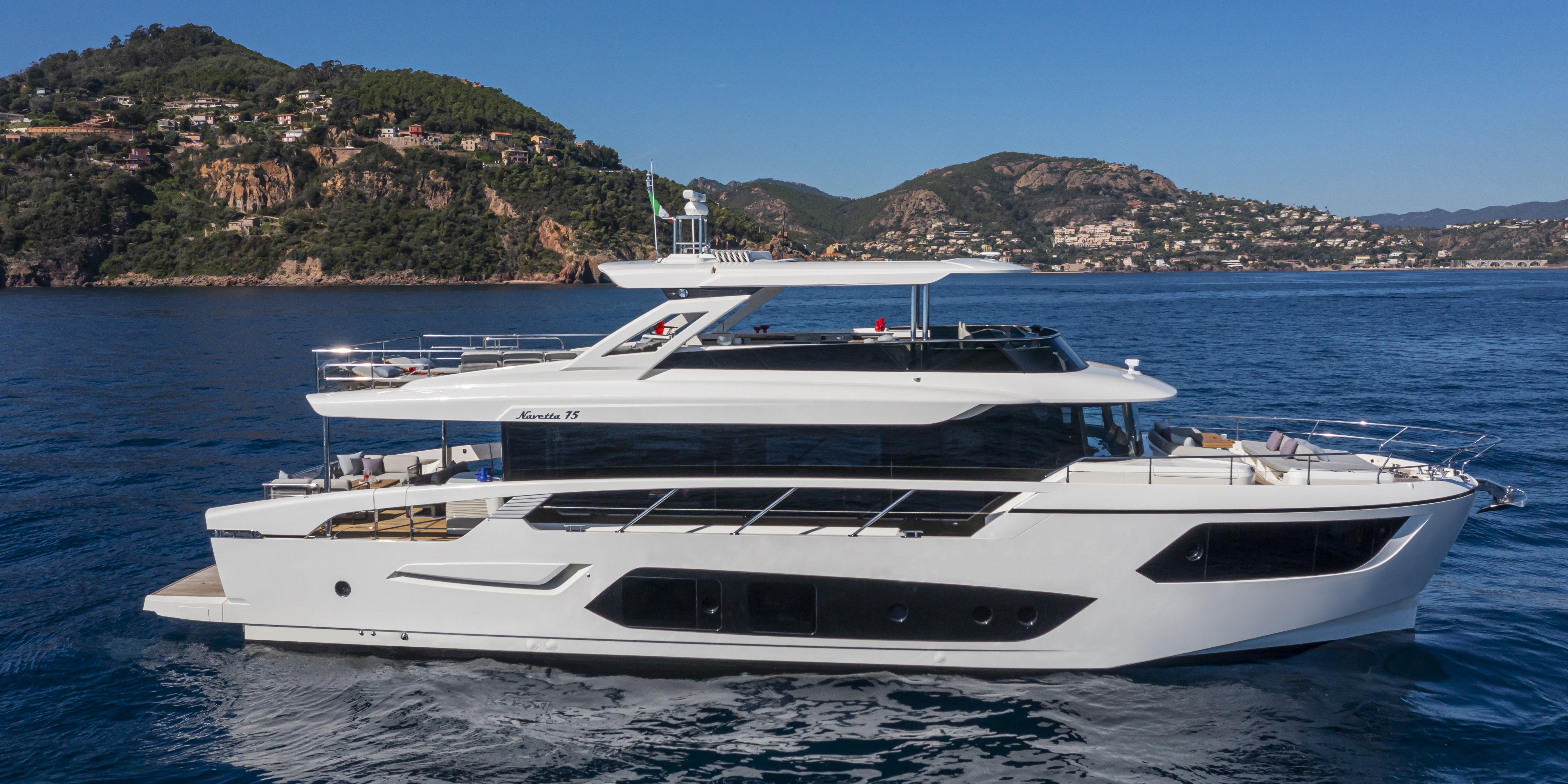 Luxury Absolute NAVETTA 75 yacht cruising near scenic coastline, 2025 model.
