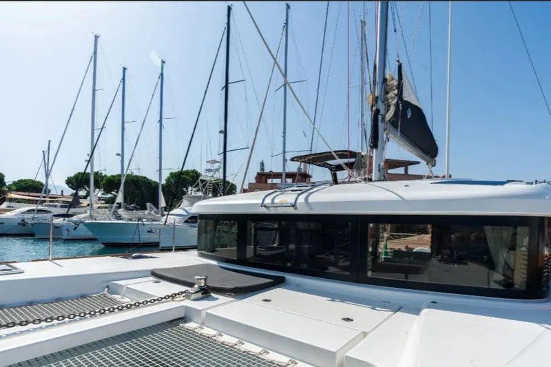  Yacht Photos Pics 2020 Lagoon 40 catamaran docked in a marina with other sailboats.