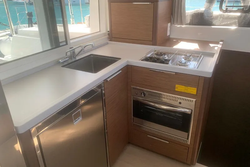  Yacht Photos Pics Modern kitchen in 2020 Lagoon 40 yacht with stove, sink, and fridge.
