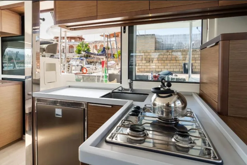  Yacht Photos Pics Modern kitchen interior of 2020 Lagoon 40 yacht with stove and kettle.