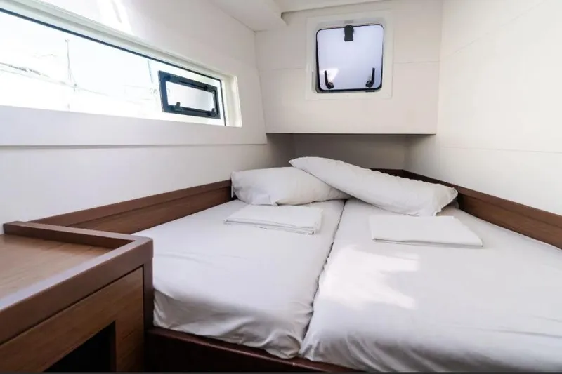  Yacht Photos Pics Interior cabin of 2020 Lagoon 40 catamaran with cozy bed and windows.