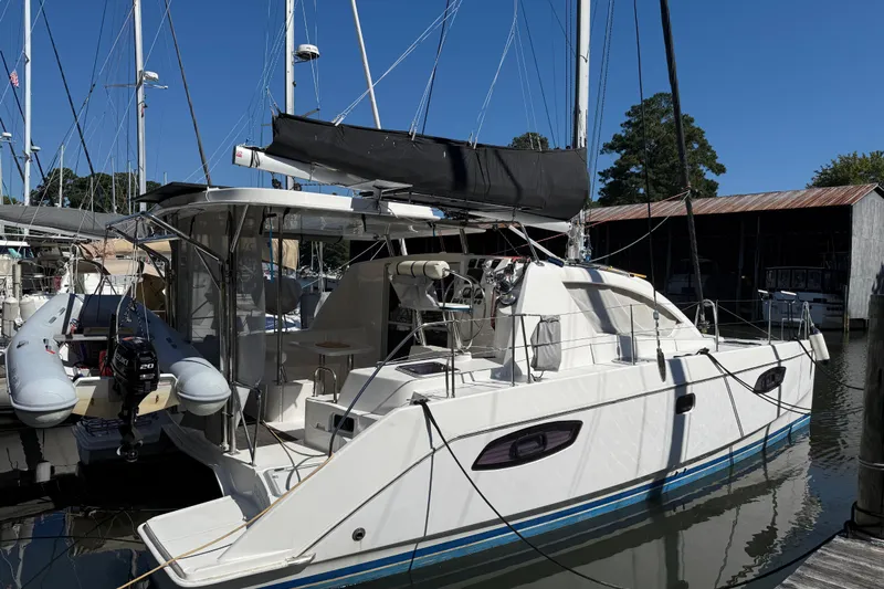 Selah Yacht Photos Pics 2010 Leopard 38 catamaran docked at marina, featuring sleek design and spacious deck.