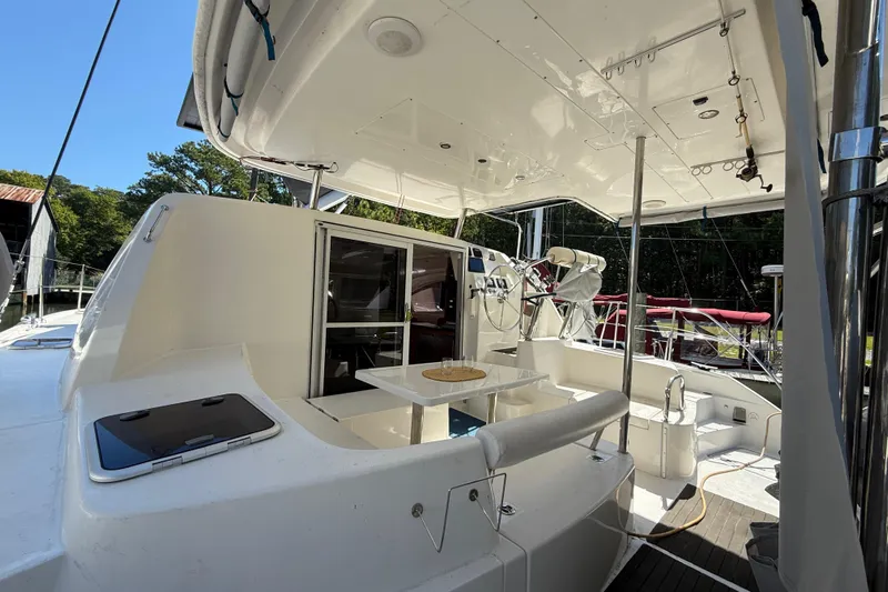 Selah Yacht Photos Pics 2010 Leopard 38 yacht cockpit with seating, table, and helm station under a canopy.
