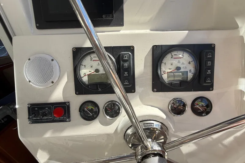 Selah Yacht Photos Pics Control panel of a 2010 Leopard 38 yacht with gauges and steering wheel.
