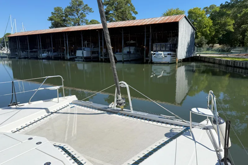 Selah Yacht Photos Pics Catamaran Leopard 38 docked near a boathouse, calm water, sunny day, 2010 model.