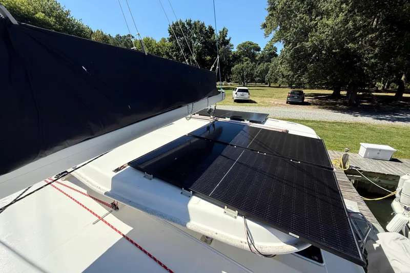Selah Yacht Photos Pics 2010 Leopard 38 catamaran with solar panels on deck, docked near a grassy area.