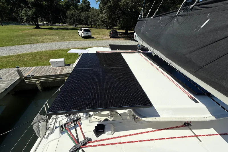 Selah Yacht Photos Pics Solar panels on a 2010 Leopard 38 catamaran docked near a grassy area.