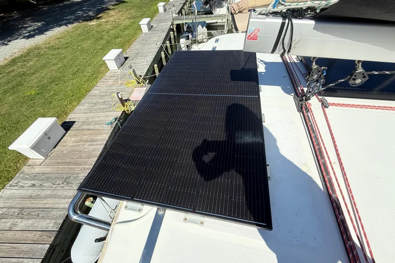 Selah Yacht Photos Pics Solar panel on Leopard 38 catamaran, docked, with visible rigging and green lawn nearby.