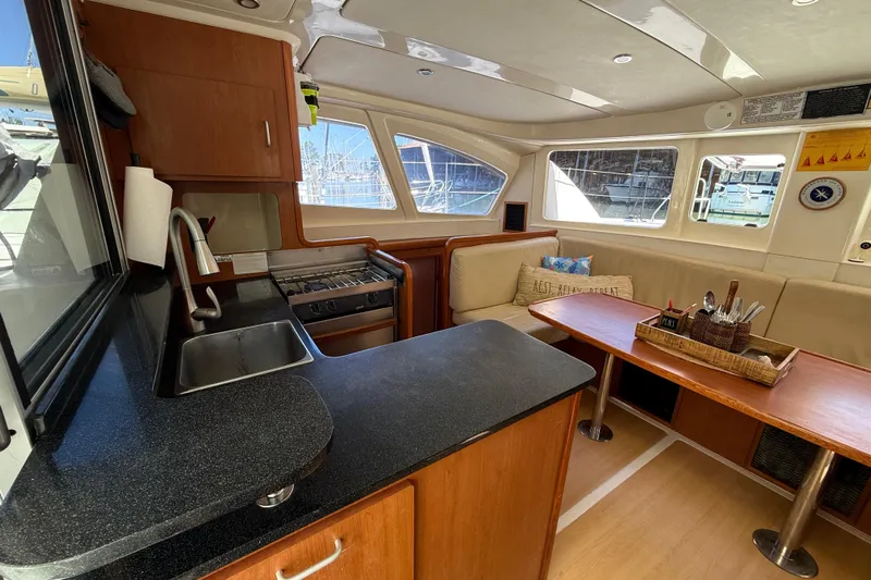 Selah Yacht Photos Pics Interior of 2010 Leopard 38 catamaran with kitchen and seating area.