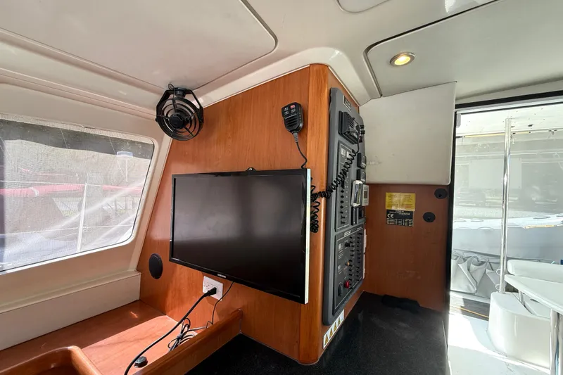 Selah Yacht Photos Pics Interior of 2010 Leopard 38 yacht with control panel and mounted TV.