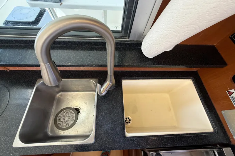 Selah Yacht Photos Pics Dual sinks with modern faucet in 2010 Leopard 38 yacht kitchen.