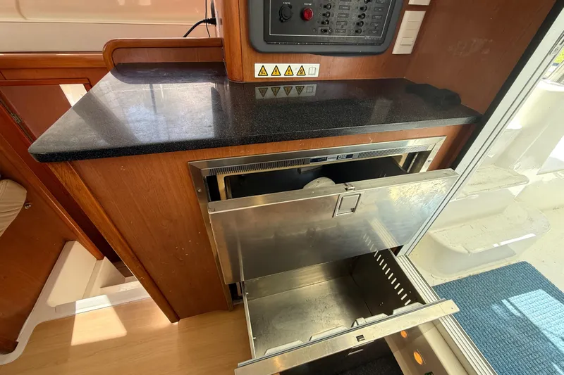 Selah Yacht Photos Pics 2010 Leopard 38 yacht interior with open stainless steel drawer and control panel.