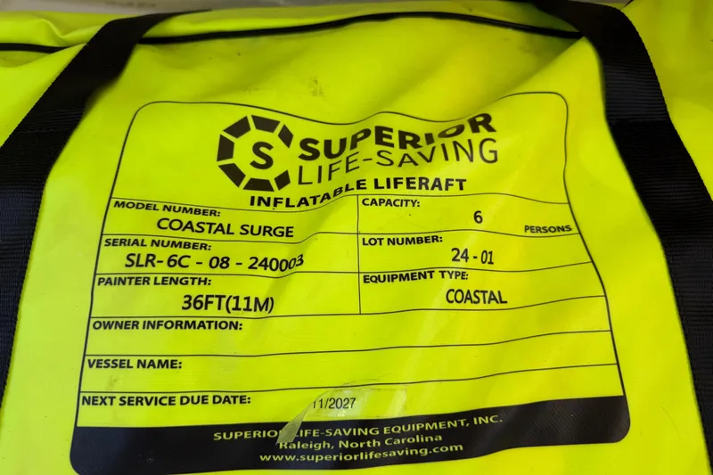 Selah Yacht Photos Pics Yellow inflatable liferaft label, model Coastal Surge, capacity 6, next service due 11/2027.