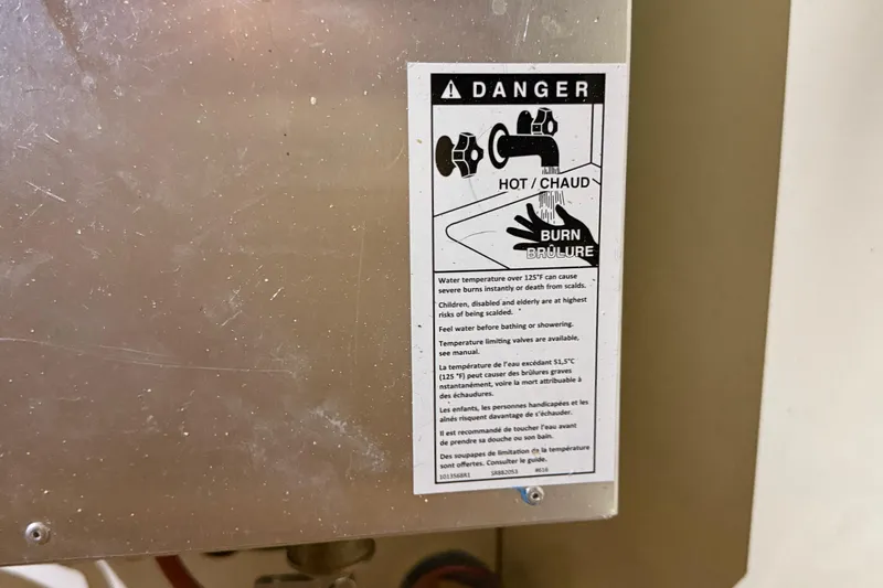 Selah Yacht Photos Pics Warning label on metal surface, indicating hot water burn risk, Leopard 38, 2010 model.