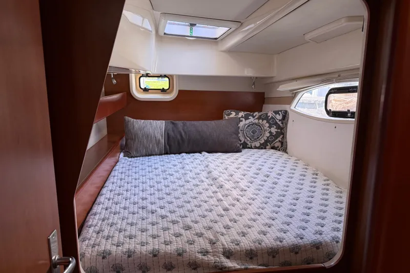 Selah Yacht Photos Pics Cozy cabin interior of 2010 Leopard 38 yacht with comfortable bedding and decorative pillows.