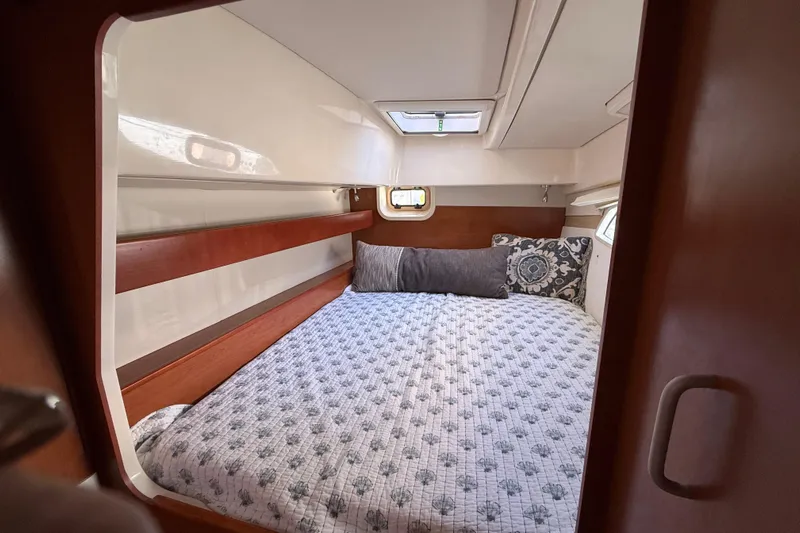 Selah Yacht Photos Pics Cozy cabin interior of 2010 Leopard 38 yacht with patterned bedding and wooden accents.