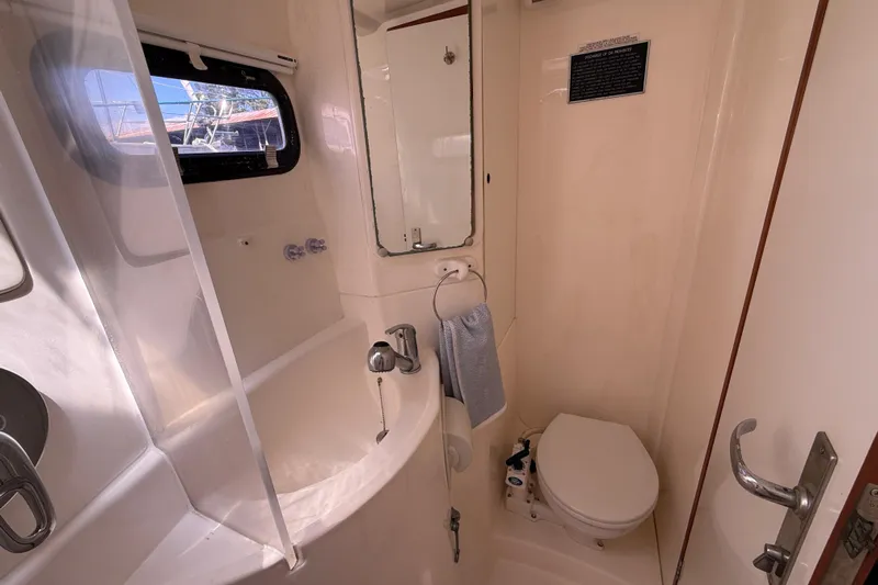 Selah Yacht Photos Pics Bathroom interior of 2010 Leopard 38 yacht, featuring sink, toilet, and window.