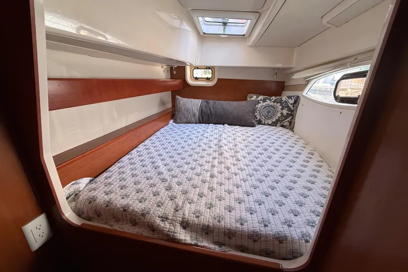Selah Yacht Photos Pics Cozy cabin interior of 2010 Leopard 38 yacht with comfortable bedding and natural light.