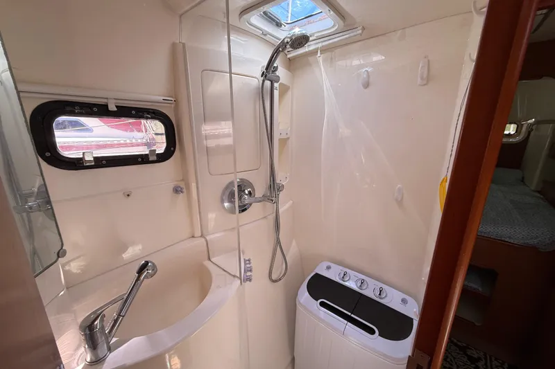 Selah Yacht Photos Pics Compact bathroom in a 2010 Leopard 38 yacht with shower and washing machine.