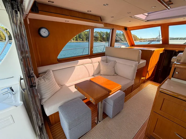 Mystique Yacht Photos Pics Luxurious 2014 Grand Banks 50 Eastbay SX yacht interior with elegant seating and scenic window views.