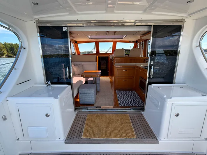 Mystique Yacht Photos Pics 2014 Grand Banks 50 Eastbay SX yacht interior with elegant seating and wooden finishes.