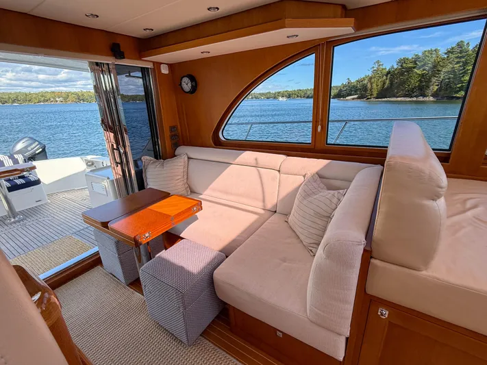 Mystique Yacht Photos Pics Luxurious interior of 2014 Grand Banks 50 Eastbay SX yacht with scenic water view.