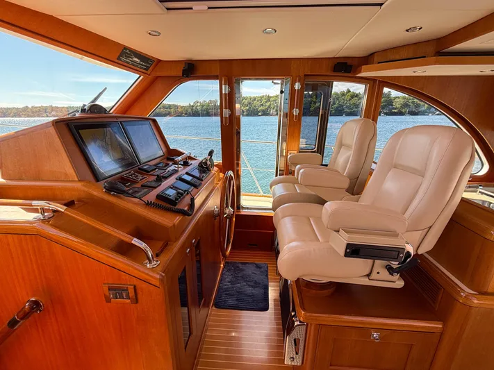 Mystique Yacht Photos Pics 2014 Grand Banks 50 Eastbay SX helm with leather seats and navigation equipment.