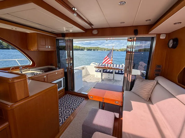 Mystique Yacht Photos Pics Interior of 2014 Grand Banks 50 Eastbay SX yacht with lake view and American flag.