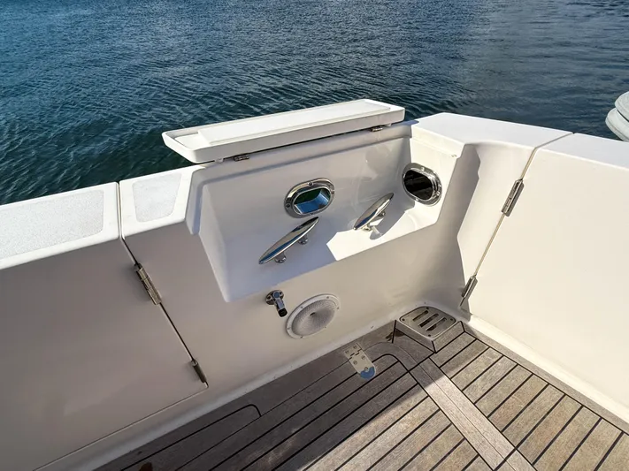 Mystique Yacht Photos Pics 2014 Grand Banks 50 Eastbay SX yacht deck with water faucet and storage.