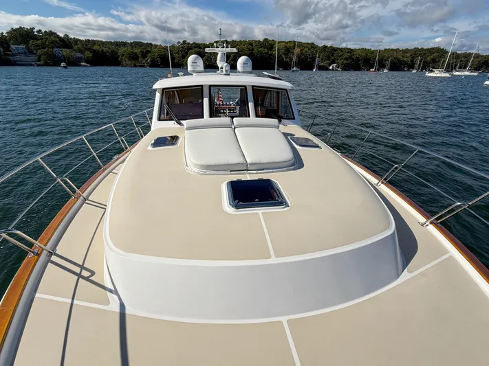 Mystique Yacht Photos Pics 2014 Grand Banks 50 Eastbay SX yacht on calm water, featuring spacious deck and sleek design.