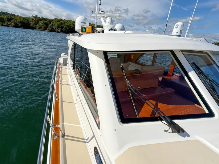 Mystique Yacht Photos Pics 2014 Grand Banks 50 Eastbay SX yacht on calm water, showcasing sleek design and spacious deck.