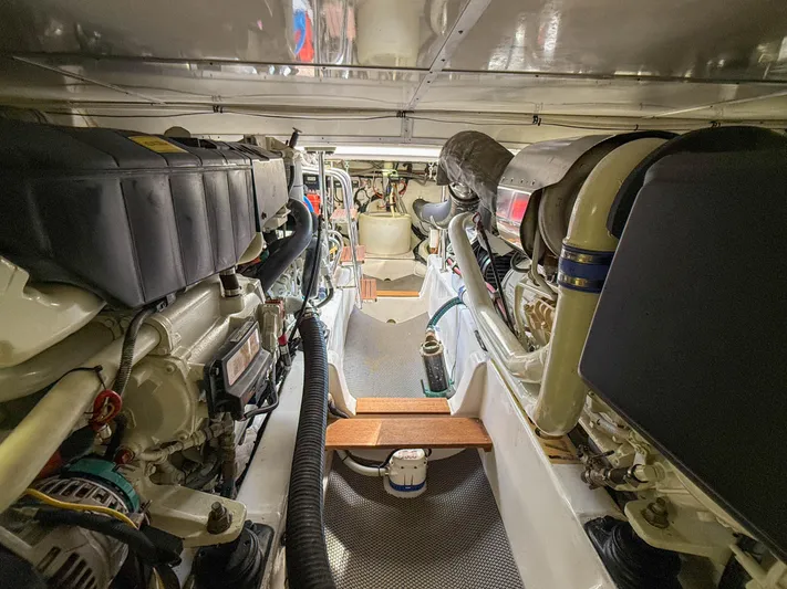 Mystique Yacht Photos Pics Engine room of 2014 Grand Banks 50 Eastbay SX yacht, showcasing dual engines and mechanical components.