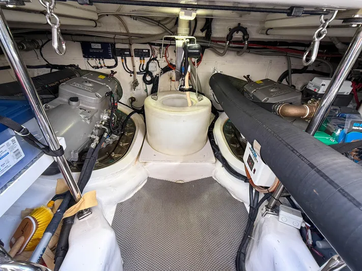 Mystique Yacht Photos Pics Engine room of 2014 Grand Banks 50 Eastbay SX yacht, showcasing dual engines and equipment.