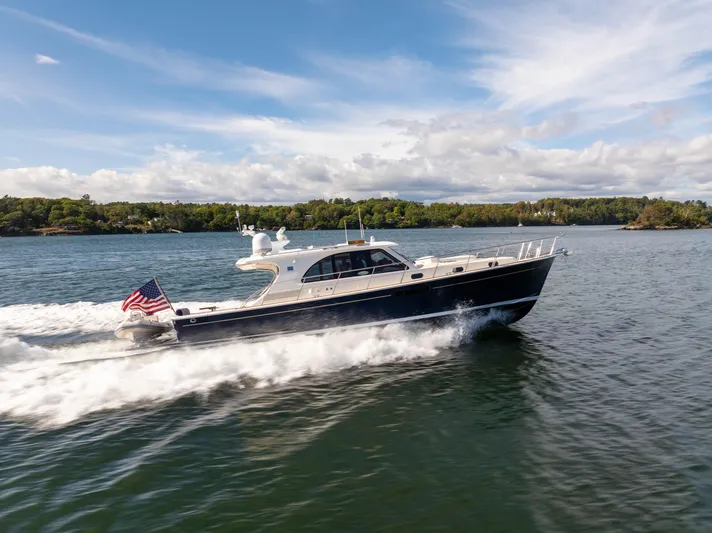 Mystique Yacht Photos Pics 2014 Grand Banks 50 Eastbay SX yacht cruising on a scenic waterway.