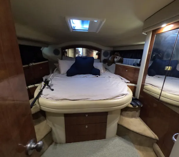  Yacht Photos Pics Luxurious cabin interior of 2003 Sea Ray 435 yacht with cozy bed and wooden furnishings.