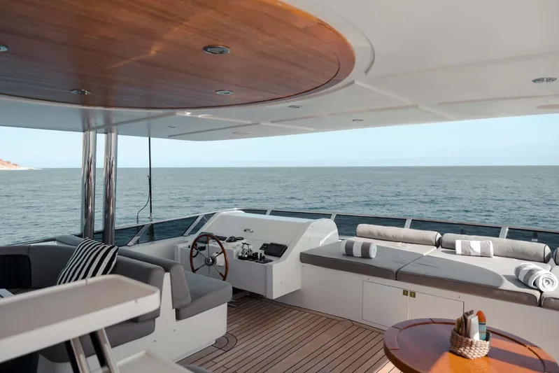  Yacht Photos Pics Luxurious 2018 Majesty 125 yacht deck with ocean view, featuring elegant seating and helm.