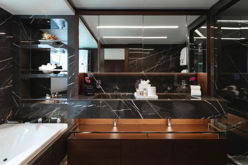  Yacht Photos Pics Luxurious yacht bathroom with black marble, modern fixtures, and elegant decor, Majesty 125, 2018.