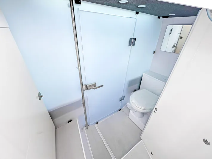  Yacht Photos Pics 2024 Axopar 37 Sun Top bathroom with modern fixtures and sleek design.