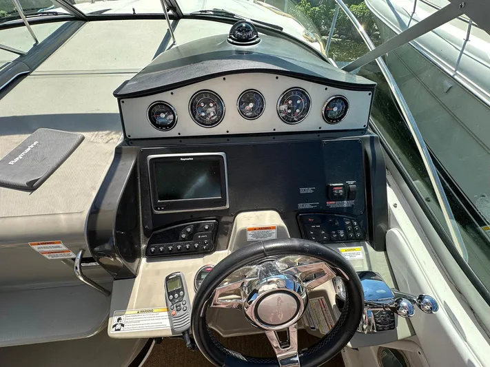 Harborviewbayview Yacht Photos Pics Helm of 2016 Sea Ray 330 Sundancer with gauges, steering wheel, and navigation system.