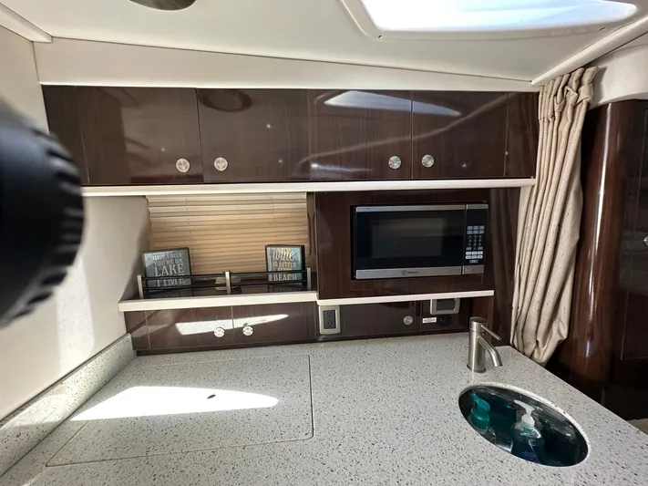 Harborviewbayview Yacht Photos Pics 2016 Sea Ray 330 Sundancer kitchen with microwave, sink, and storage cabinets.