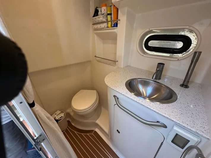 Harborviewbayview Yacht Photos Pics Bathroom interior of 2016 Sea Ray 330 Sundancer with sink, toilet, and window.