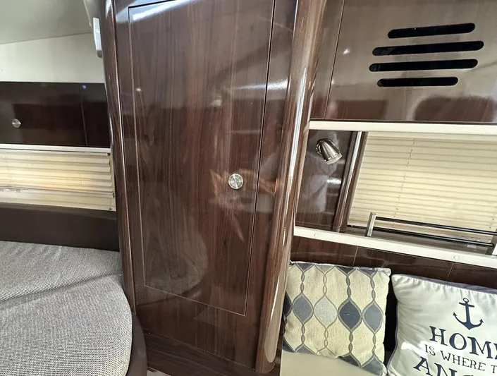 Harborviewbayview Yacht Photos Pics Interior of 2016 Sea Ray 330 Sundancer with wood paneling and decorative pillows.