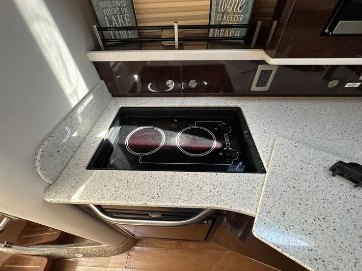 Harborviewbayview Yacht Photos Pics Modern kitchen in 2016 Sea Ray 330 Sundancer yacht with electric cooktop and granite countertop.