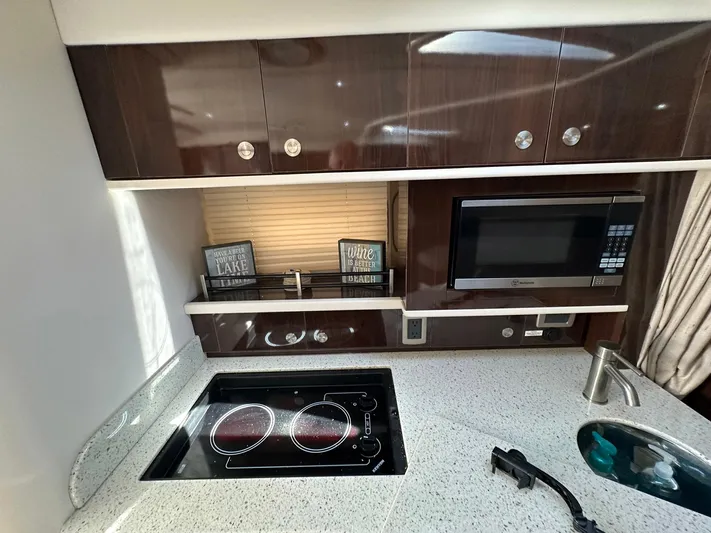 Harborviewbayview Yacht Photos Pics 2016 Sea Ray 330 Sundancer kitchen with stove, microwave, and modern cabinetry.