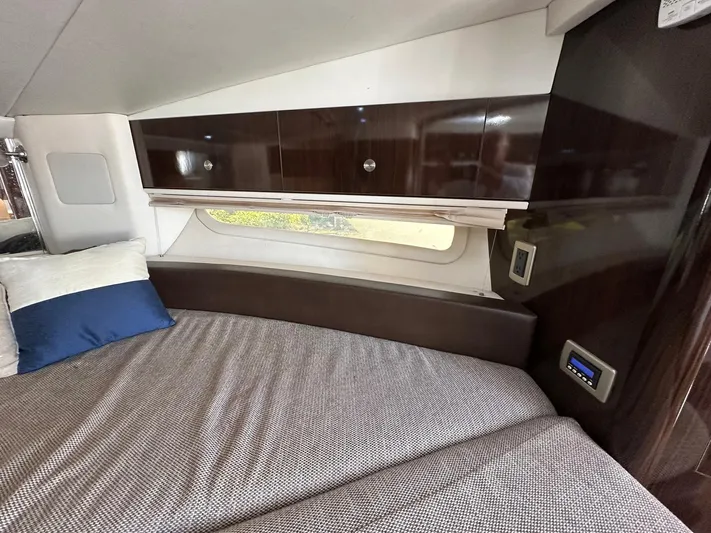 Harborviewbayview Yacht Photos Pics Interior cabin of 2016 Sea Ray 330 Sundancer with bed, pillows, and storage cabinets.