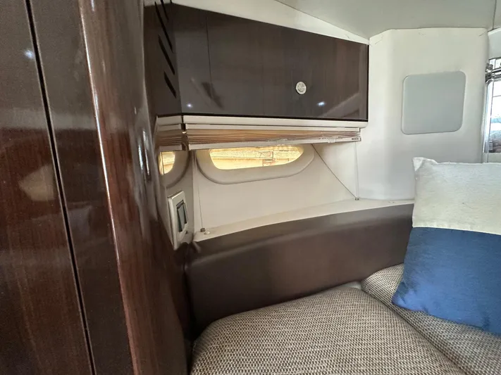 Harborviewbayview Yacht Photos Pics Interior cabin of 2016 Sea Ray 330 Sundancer with wood cabinetry and cushioned seating.