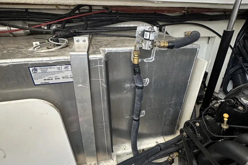 Harborviewbayview Yacht Photos Pics Engine compartment of a 2016 Sea Ray 330 Sundancer boat, showing fuel tank and hoses.