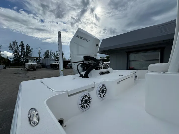  Yacht Photos Pics 2025 Shallow Sport 25 X3 boat with Mercury engine, docked under cloudy sky.