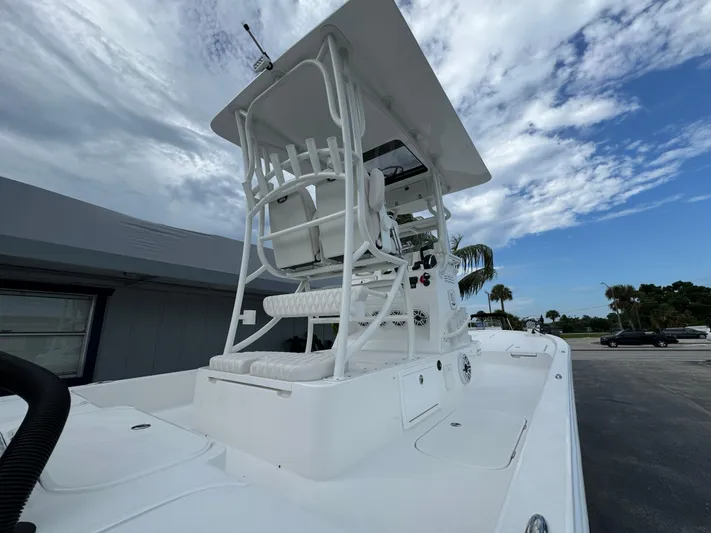  Yacht Photos Pics 2025 Shallow Sport 25 X3 boat with elevated helm station under a cloudy sky.
